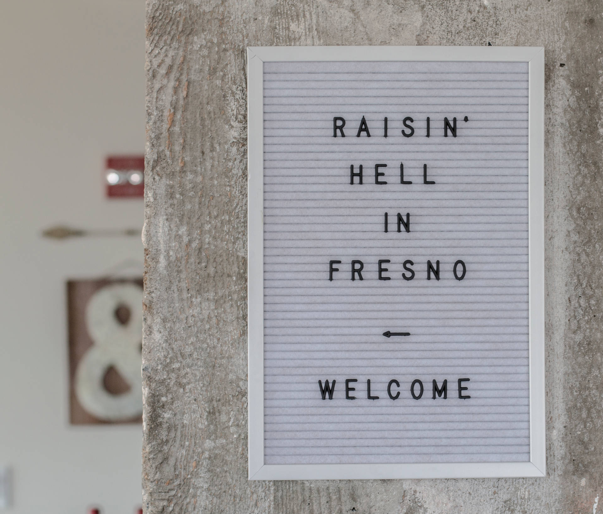 Raisin Hell In Fresno Sign Background