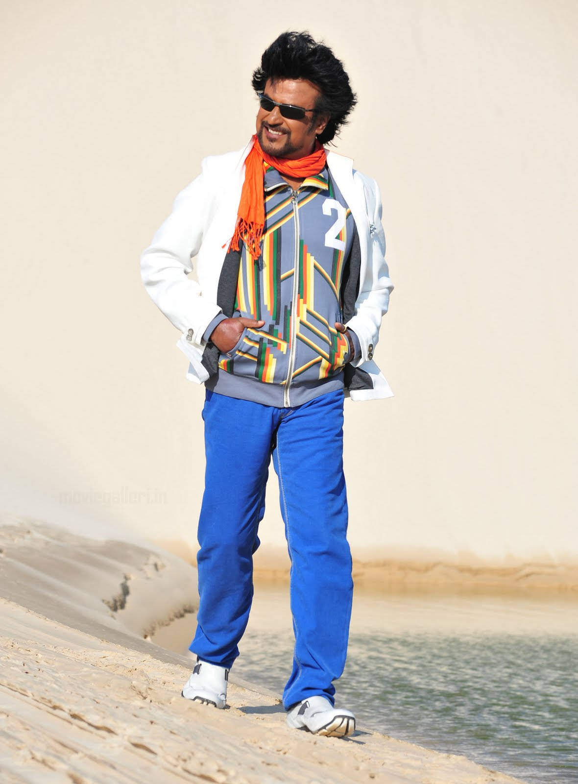 Rajinikanth, Indian Superstar, Boldly Trekking Across Desert Dunes. Background