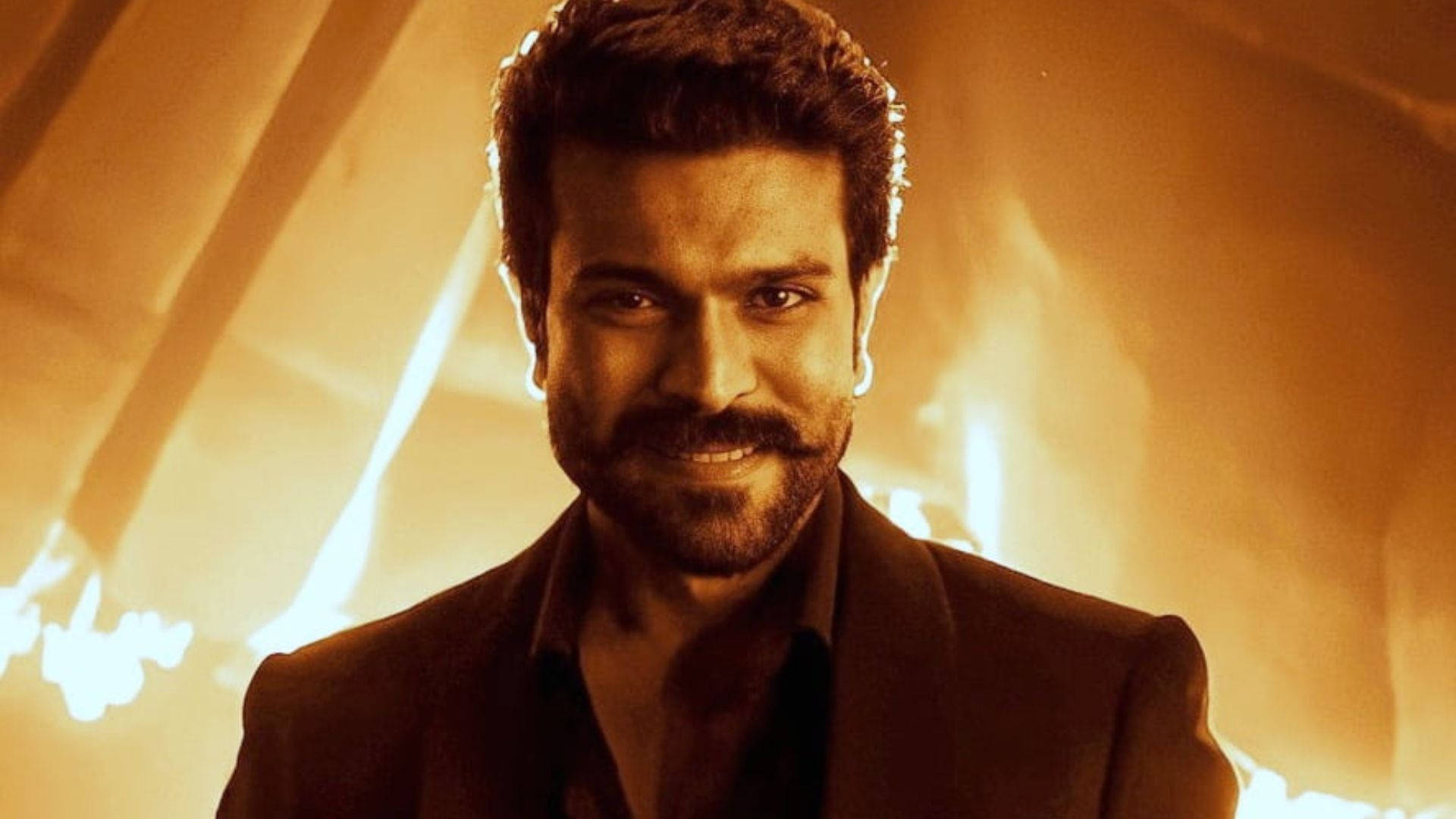Ram Charan In High Definition Looking Dashing Against A Fiery Background Background