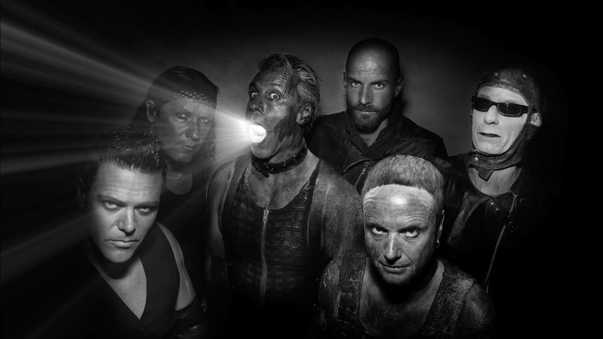 Rammstein Band Members Dramatic Lighting Background