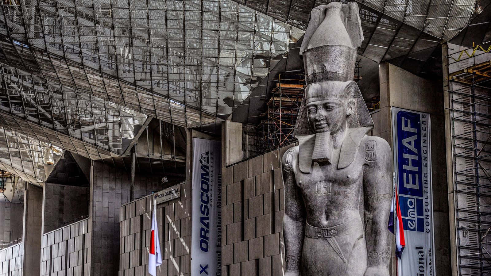 Ramses Ii Red Granite Statue Inside The Grand Egyptian Museum Background