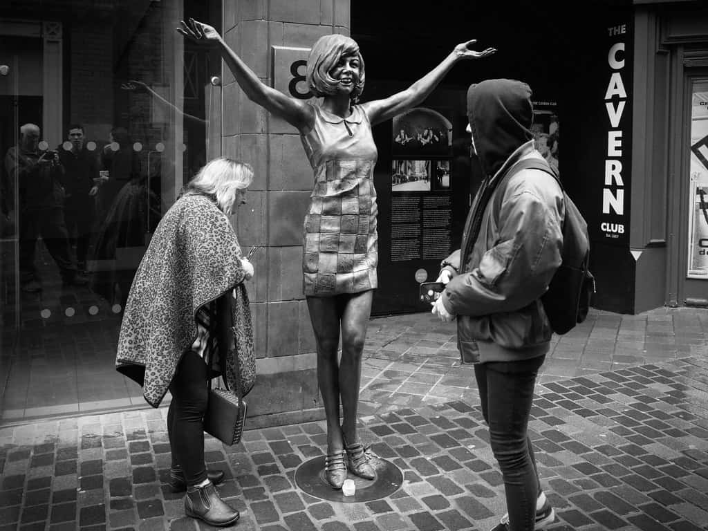 Random People Looking At Statue