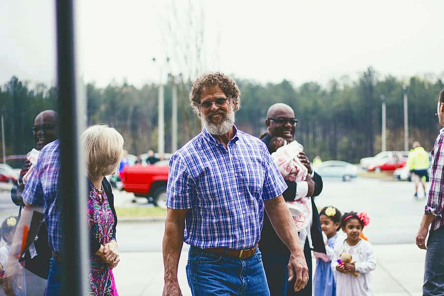 Random People Passing By A Sidewalk