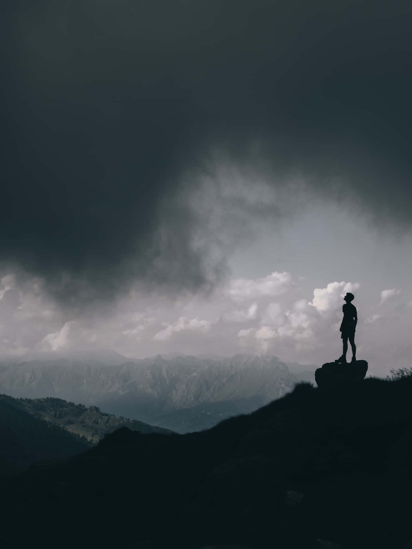 Random Person Standing On Top Of Rock Background