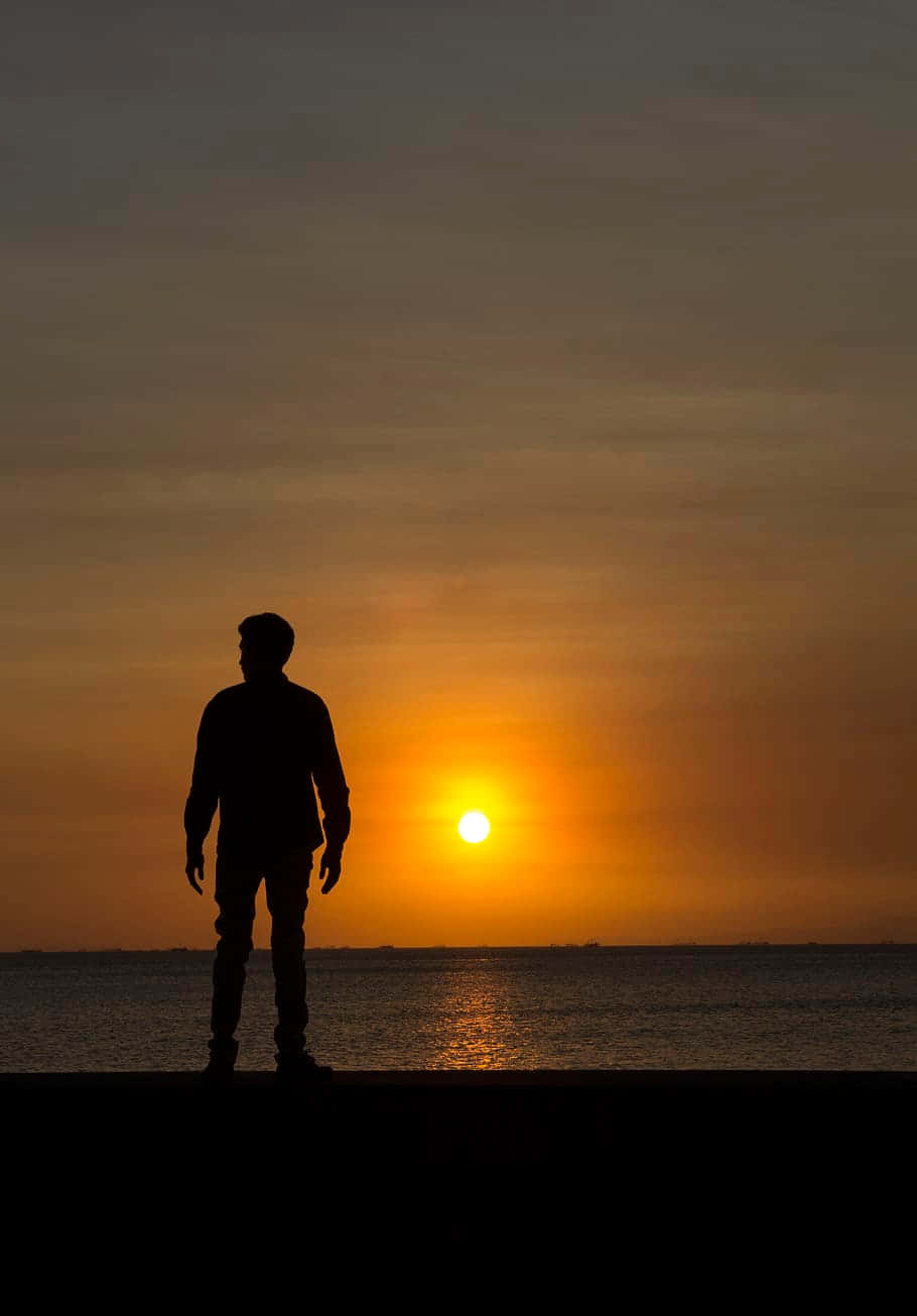 Random Person Watching Ocean Sunset Background