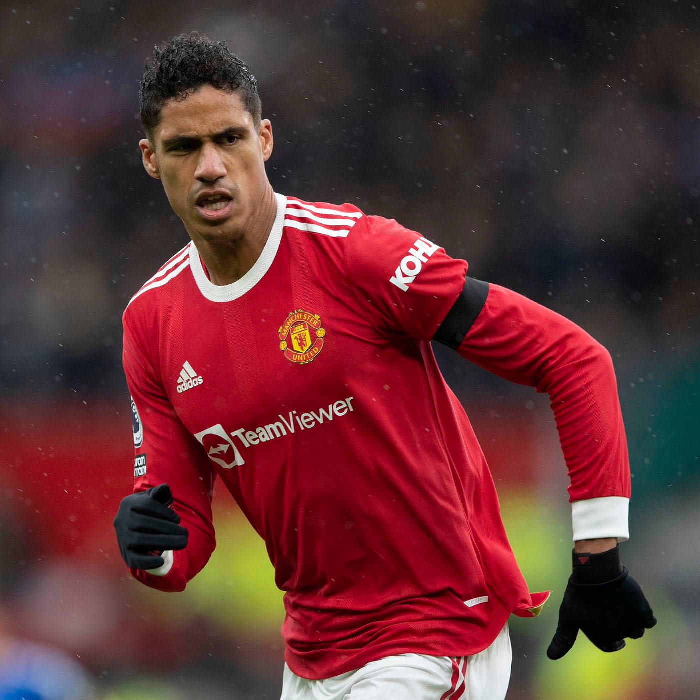 Raphael Varane Black Gloves Red Background