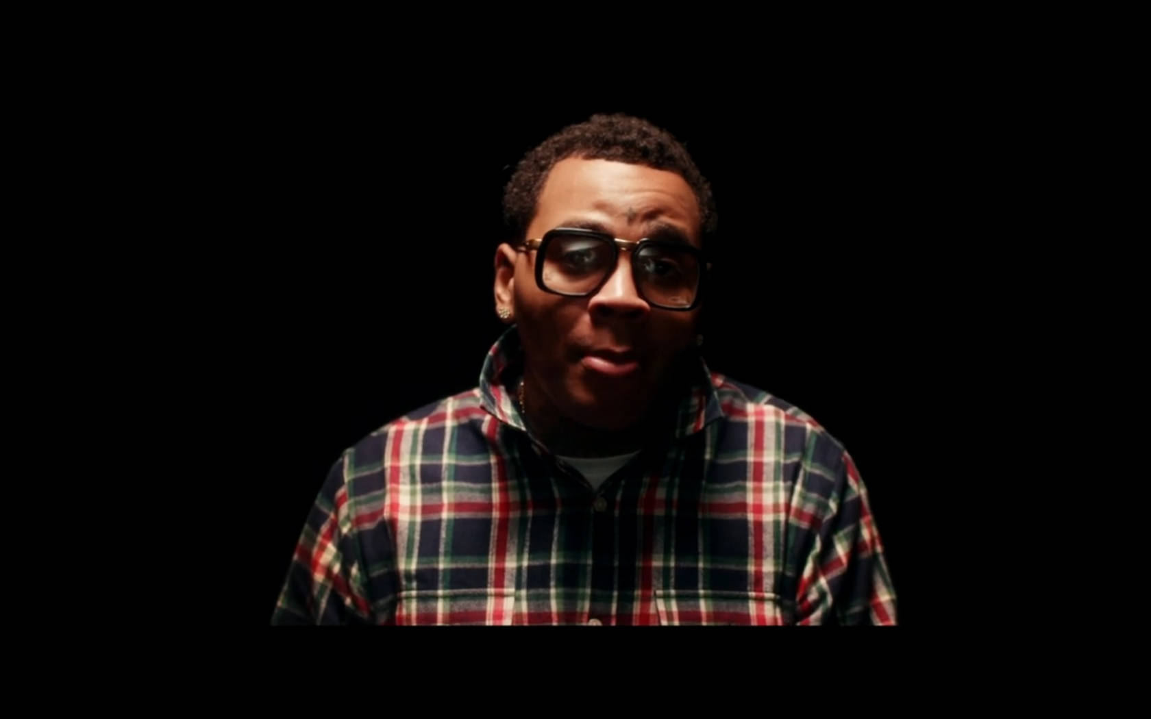 Rapper Kevin Gates Performing In The Spotlight Background