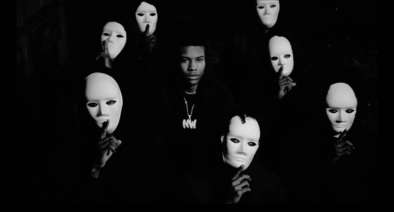 Rapper Nardo Wick With Men In White Masks Background