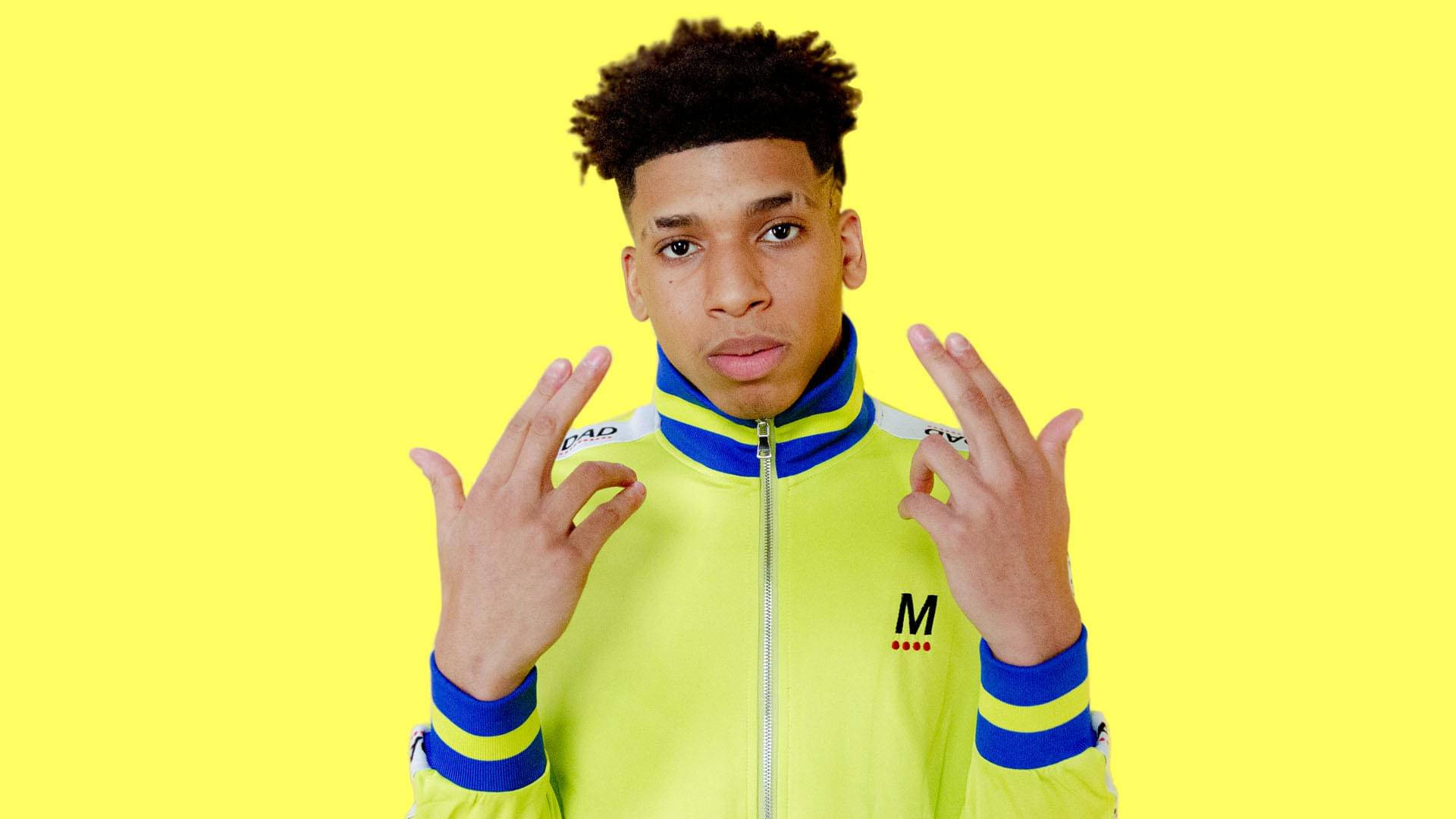 Rapper Nle Choppa Stands Ready With A Microphone.