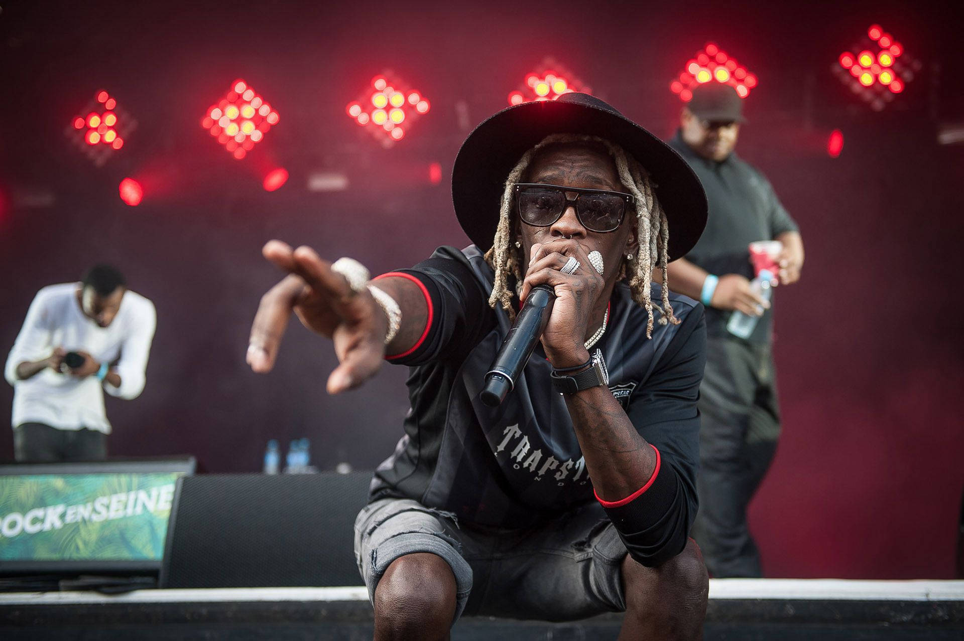 Rapper Young Thug Brings The Audience To Their Feet During A Live Performance Background