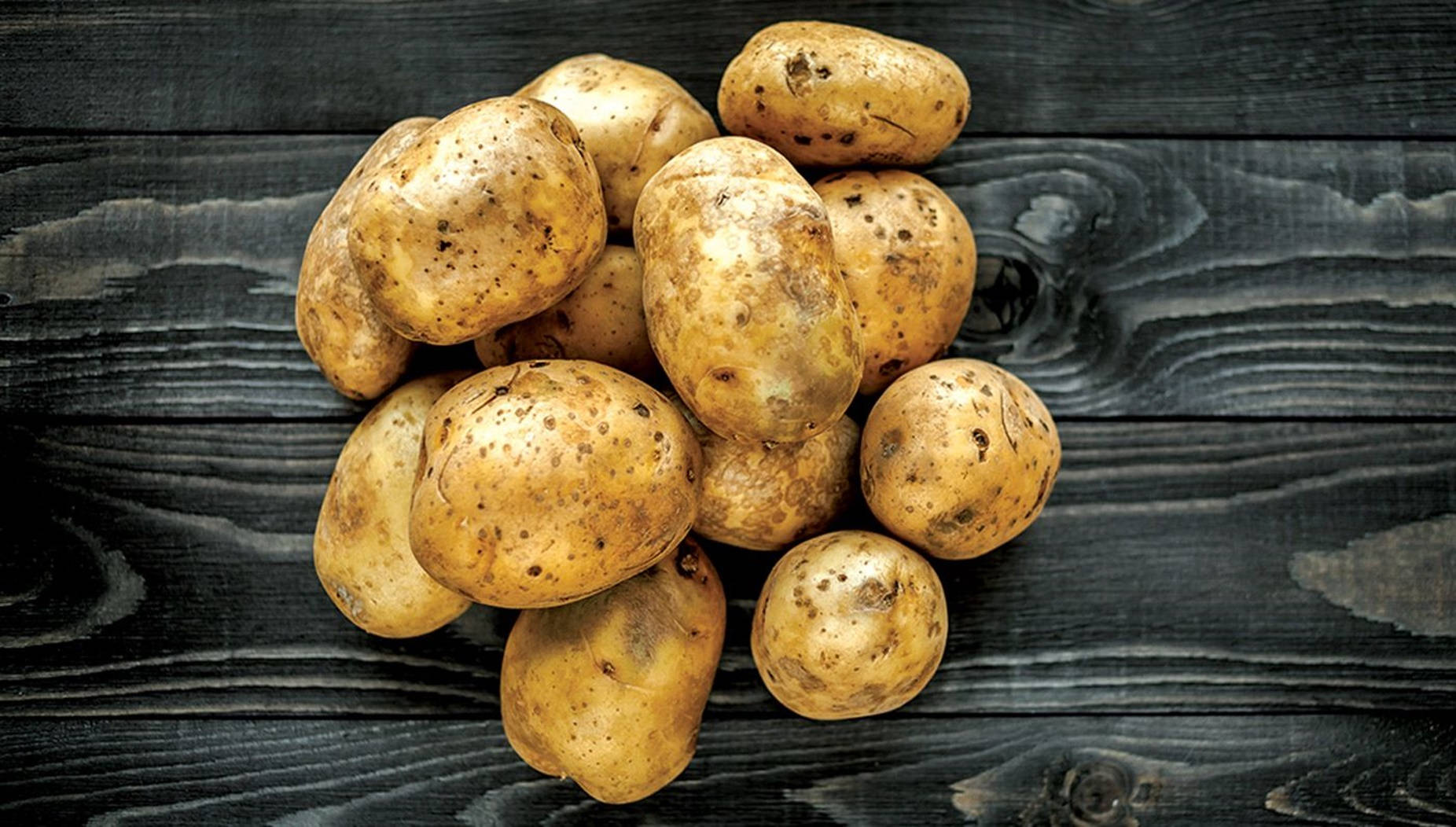 Raw Potatoes In Their Natural, Uneven Shapes Background