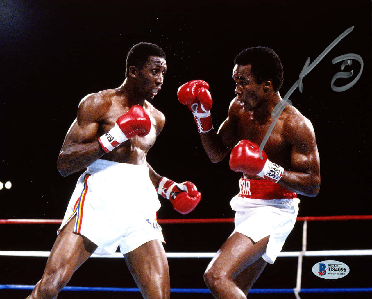 Ray Leonard Boxing And Surrounded By Darkness Background