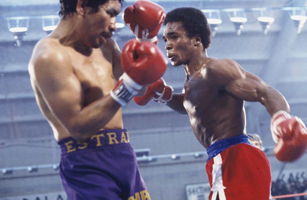 Ray Leonard Boxing With A Blue Backdrop Background
