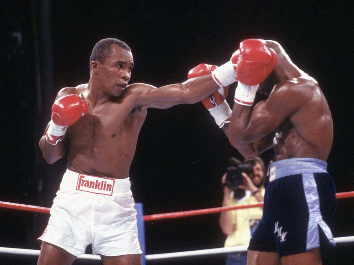 Ray Leonard Breaking Through Opponent's Guard Background