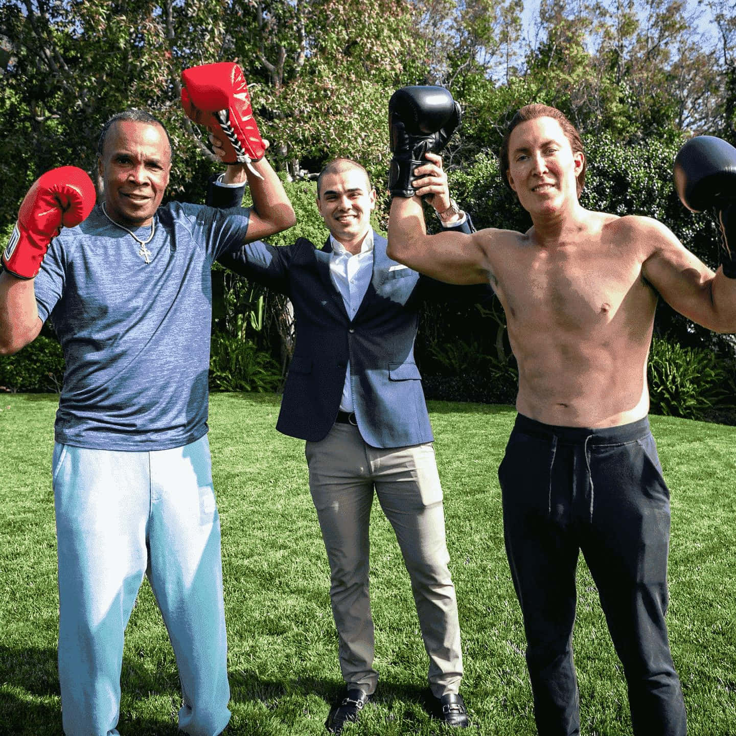 Ray Leonard Flexing With Other Boxer Outdoors Background