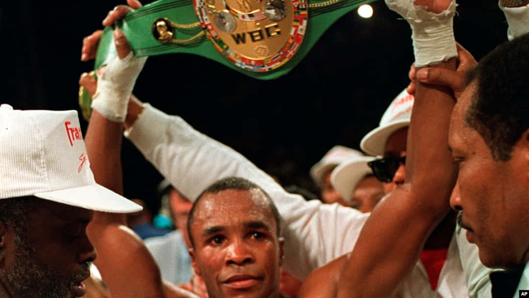 Ray Leonard Holding Up His Title Belt Background