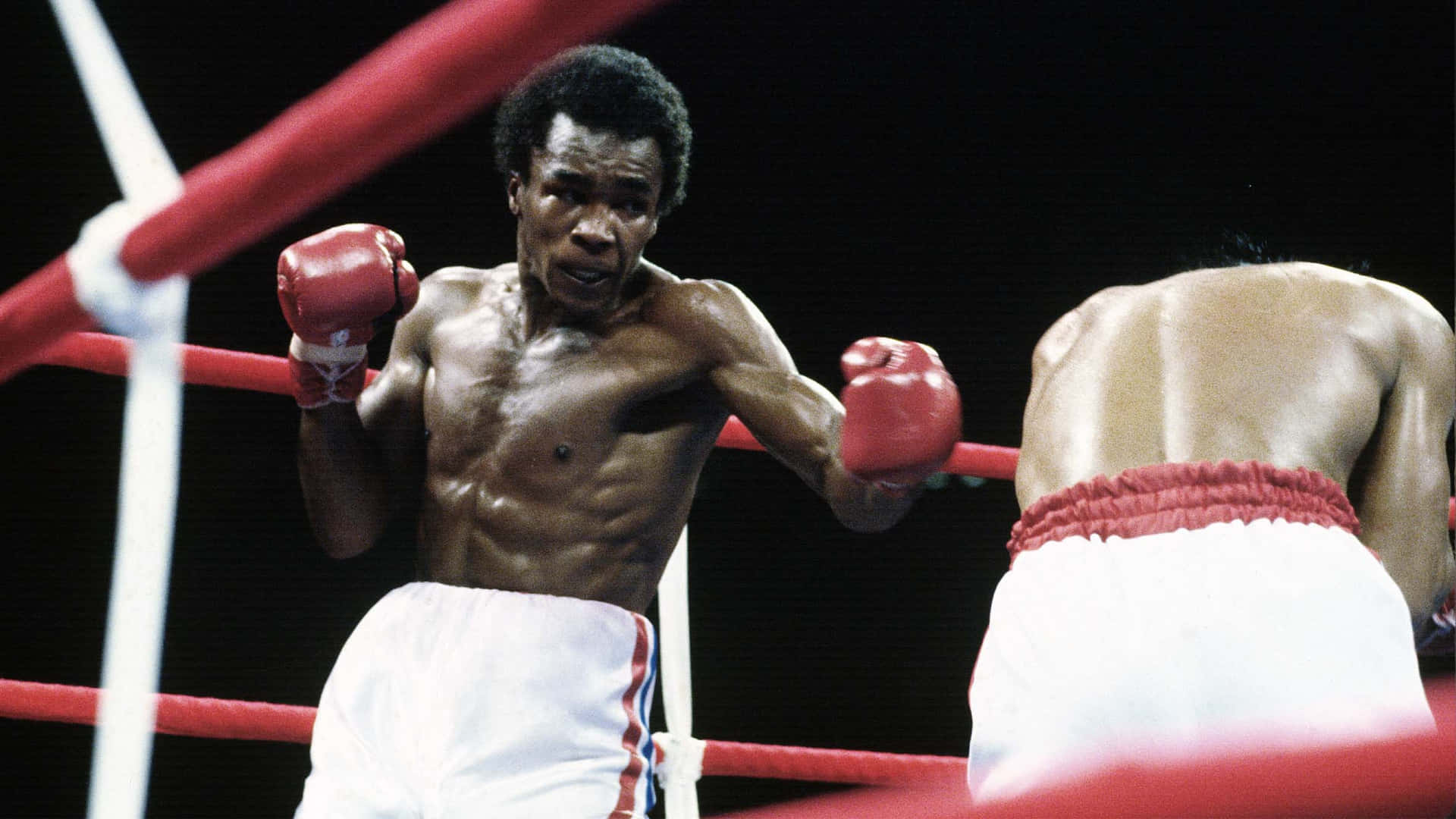Ray Leonard Stands Over Foe With Black Backdrop Background