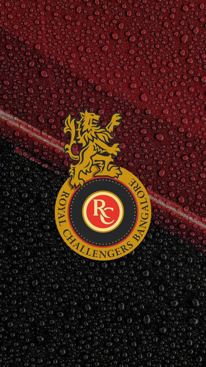 Rcb Team Logo On Wet Surface Background