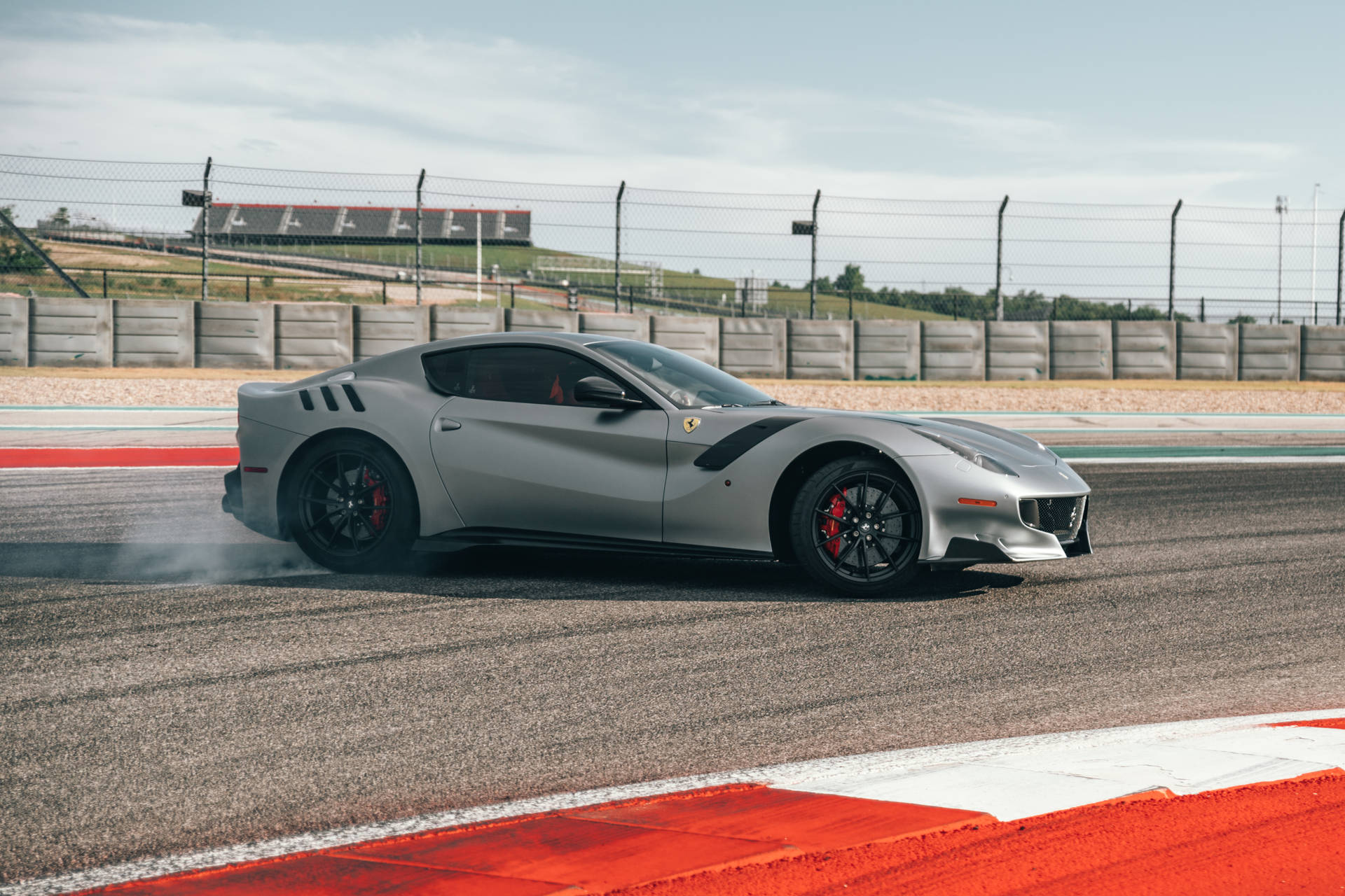 Reach Your Top Speed On The Track With The Silver Ferrari Background