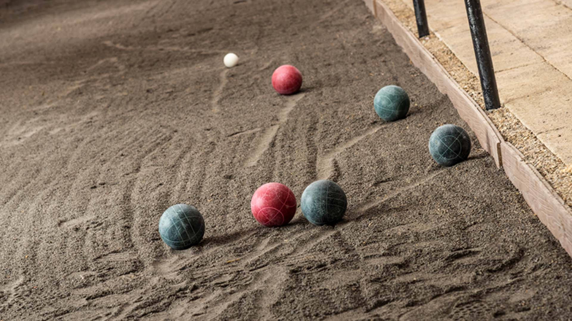 Ready For The Toss - Bocce Ball On Sand Court Background