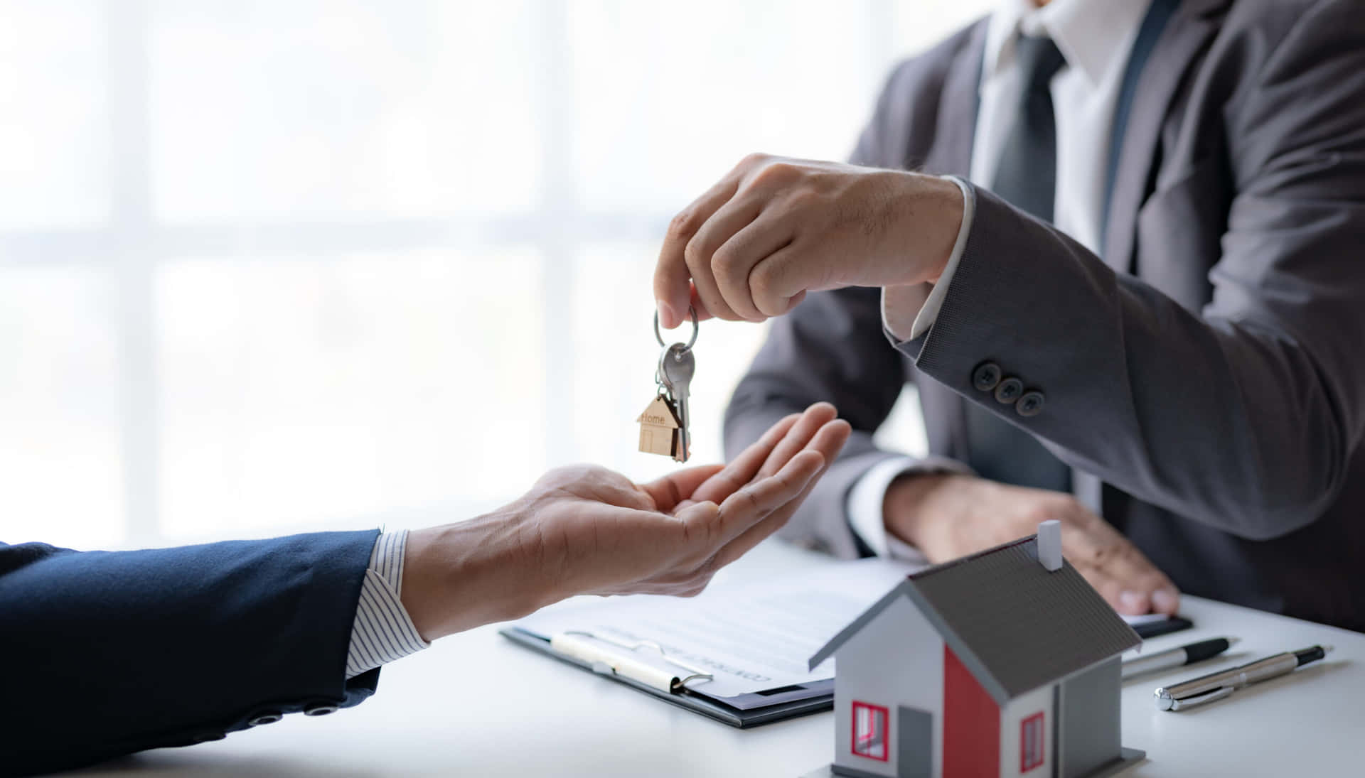 Real Estate Agent Handing Over House Keys Background