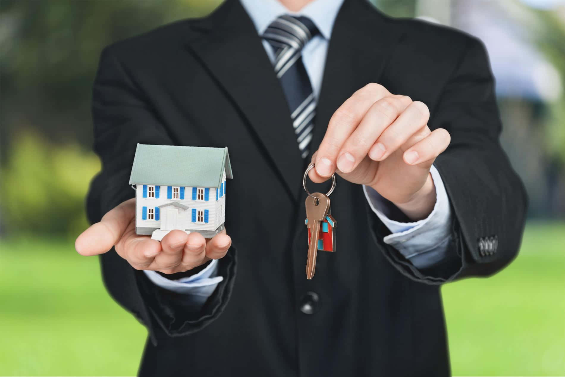 Real Estate Agent Holding Houseand Keys Background