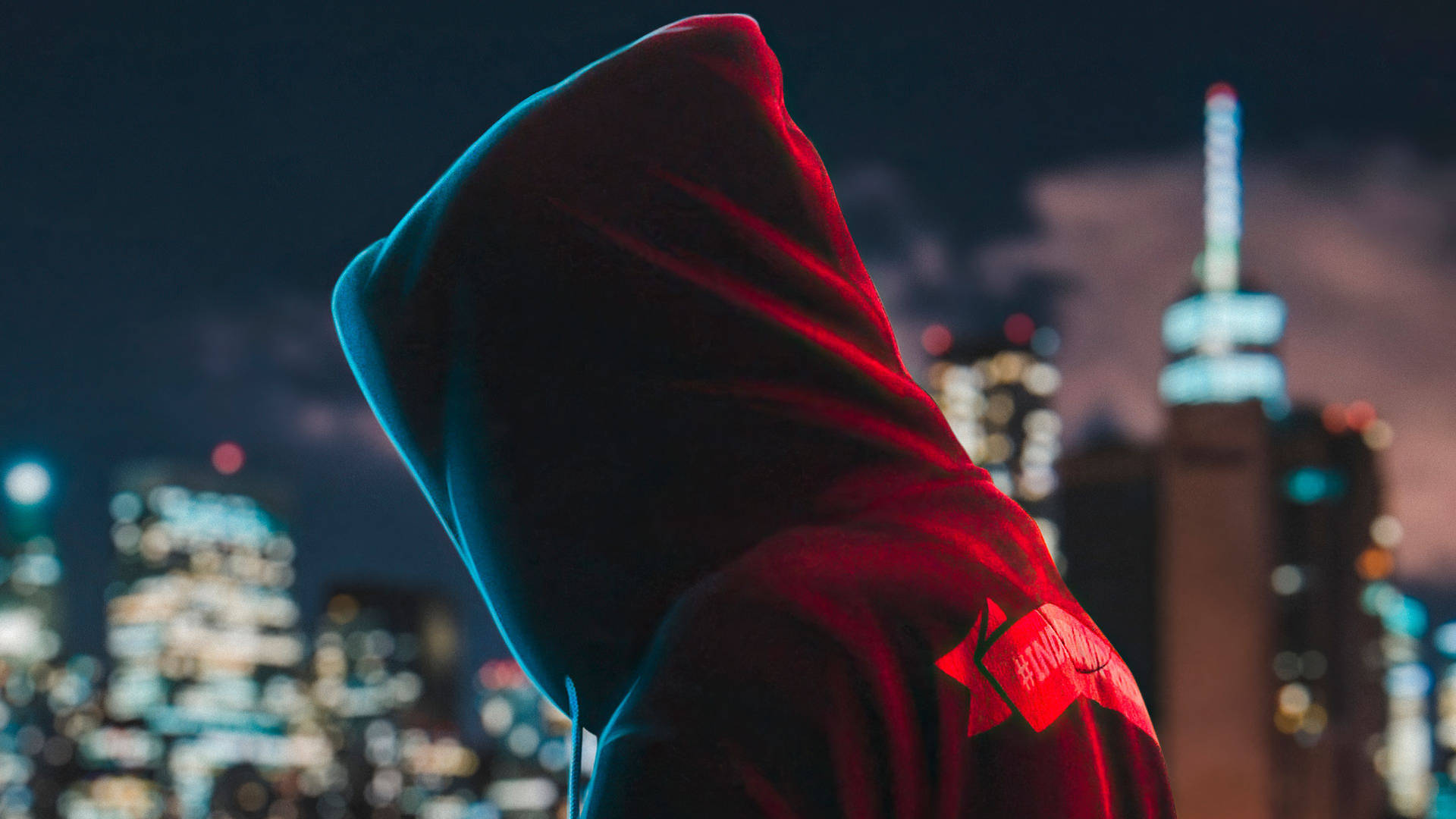 Red And Blue Hoodie In City Background