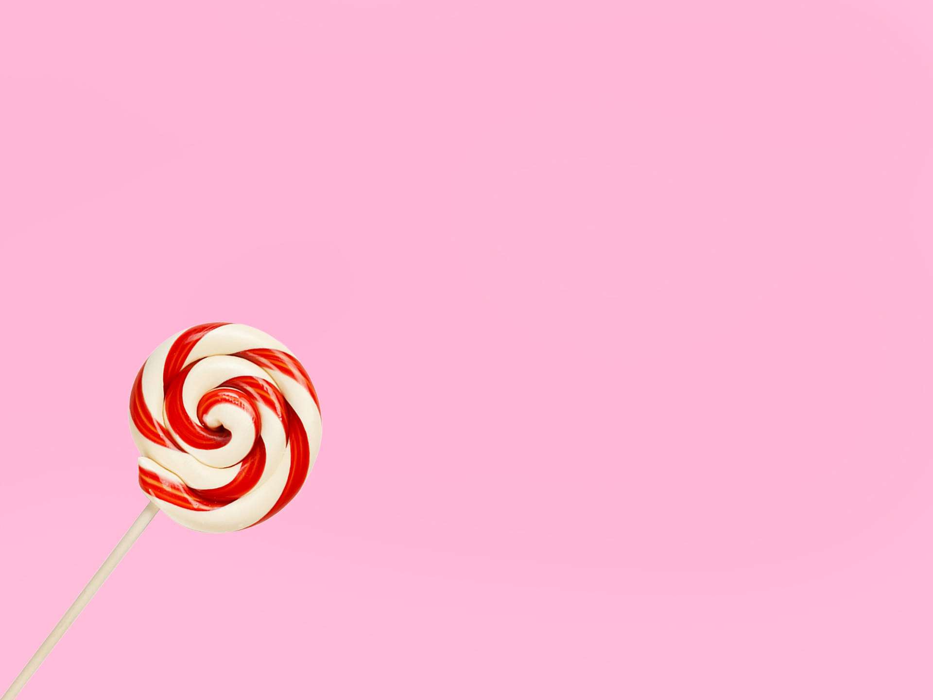 Red And White Lollipop On Pink Background