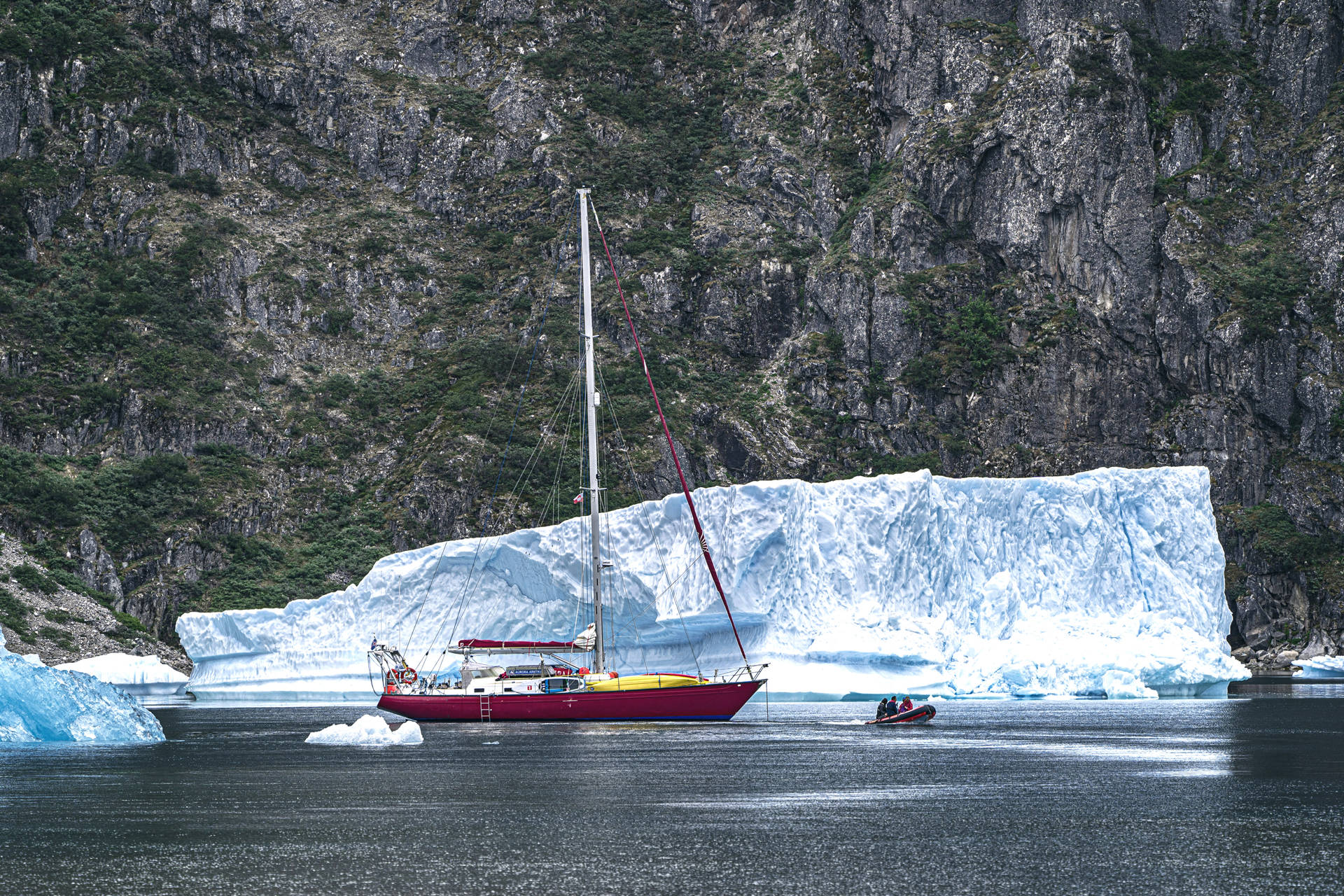 Red Boat And Greenland Ice Berg Background