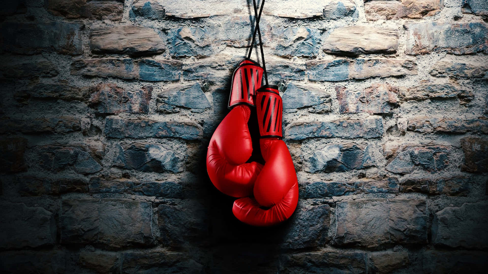 Red Boxing Gloves Hanging Stone Wall Background