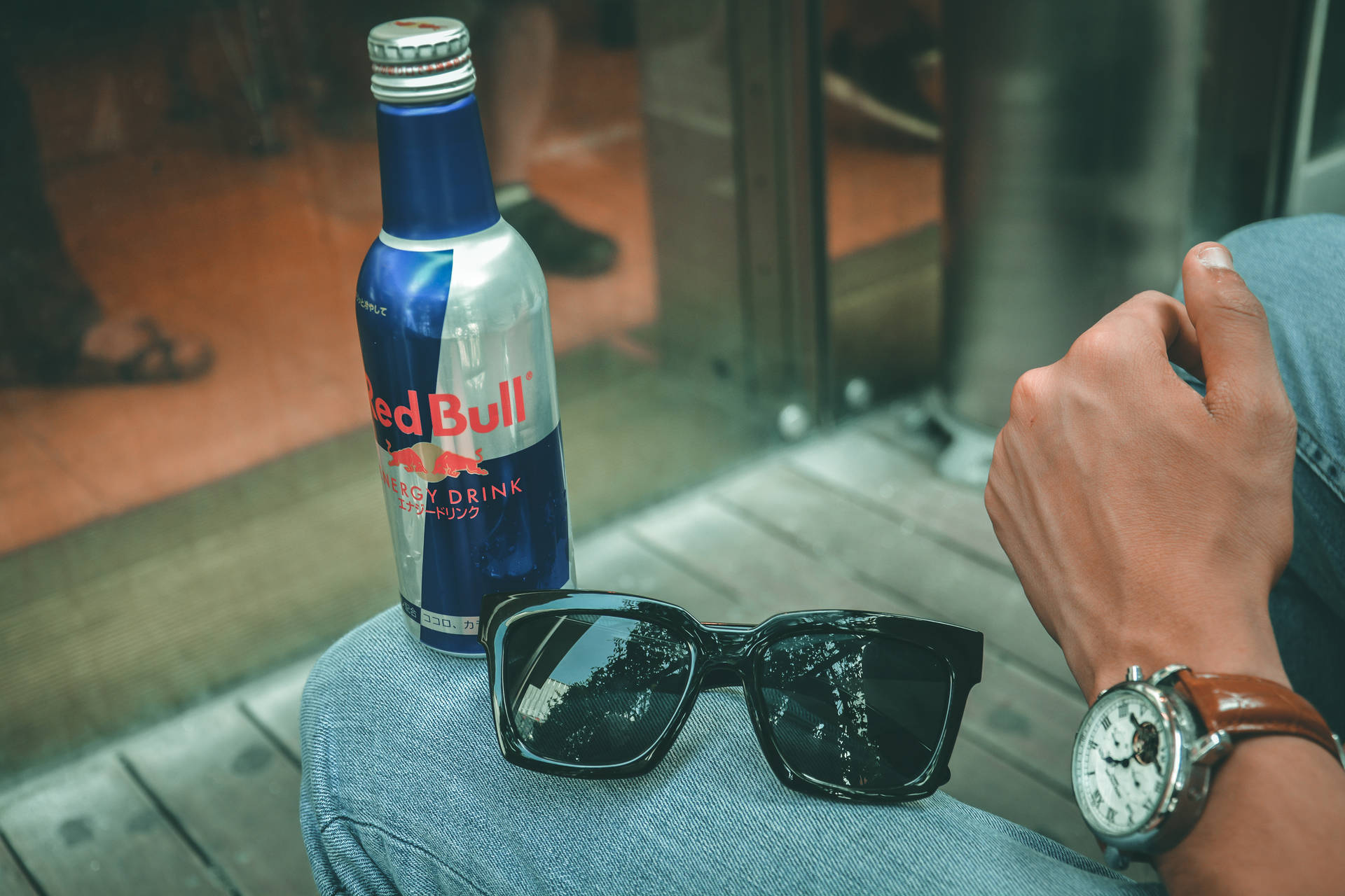 Red Bull Bottle Glasses On Jeans Background