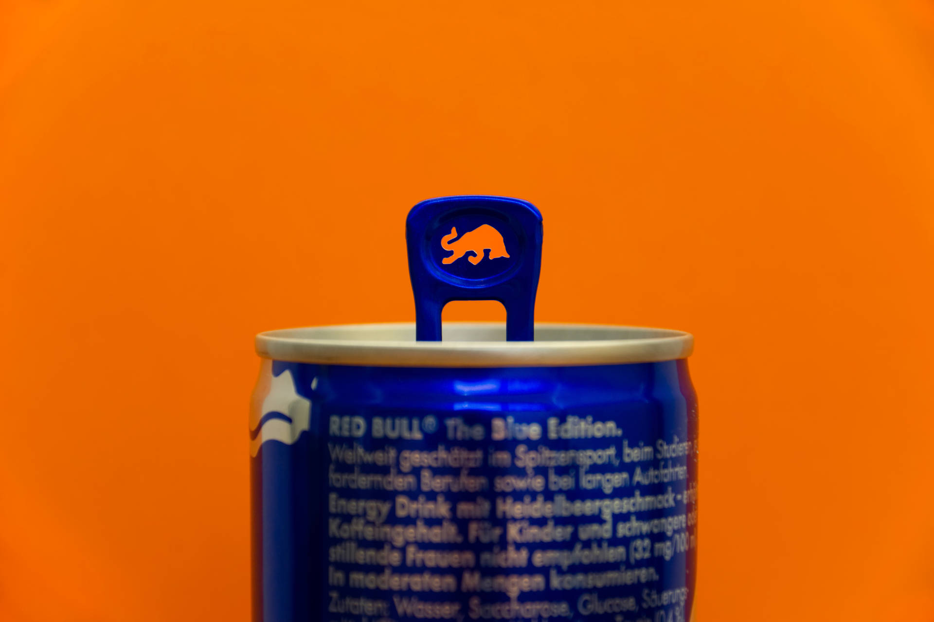 Red Bull Can On Orange Wall Background