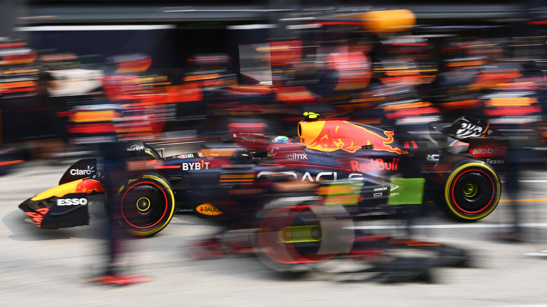 Red Bull Racing Team In Action Background