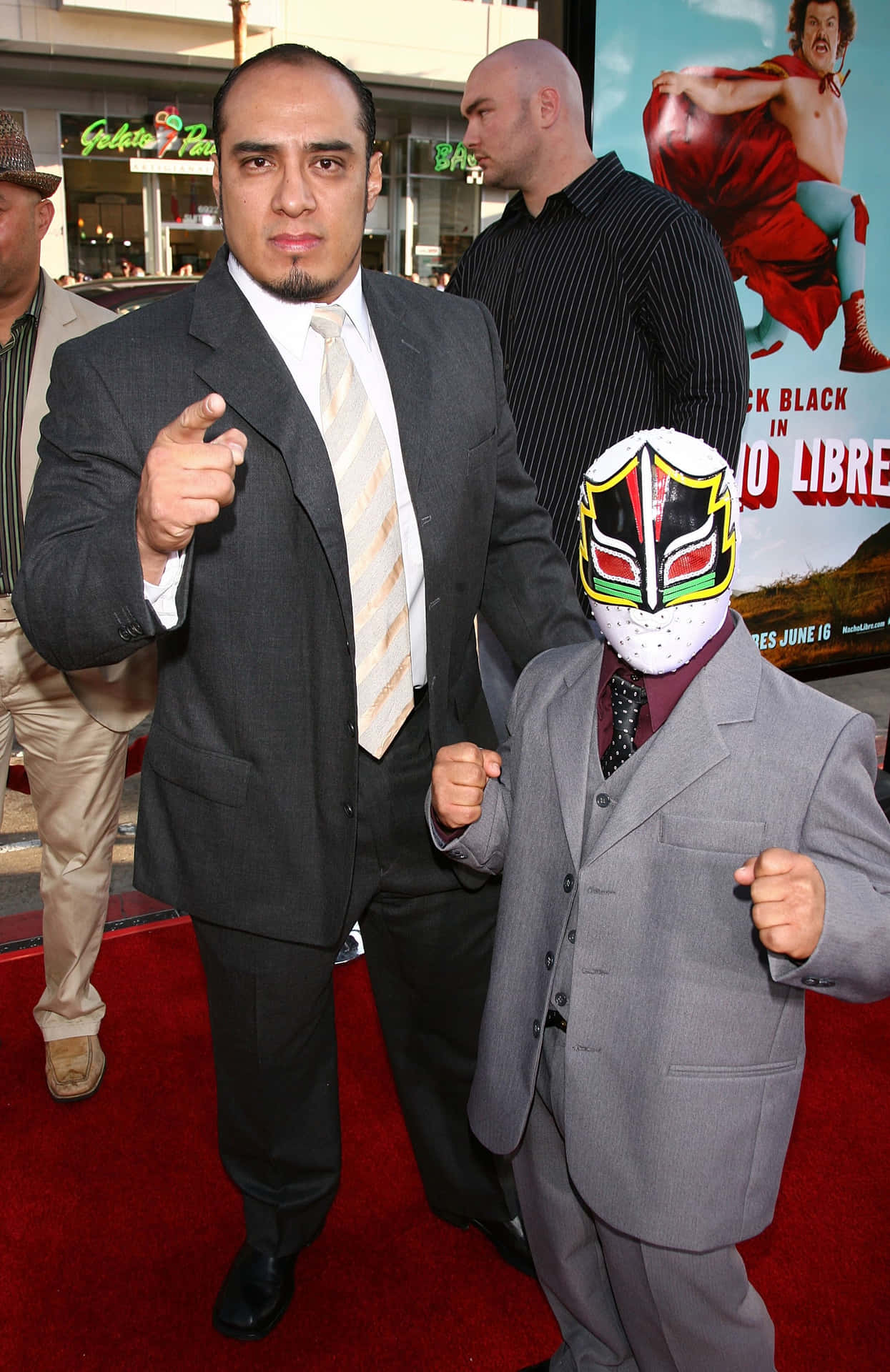 Red Carpet Event With Masked And Unmasked Men Background