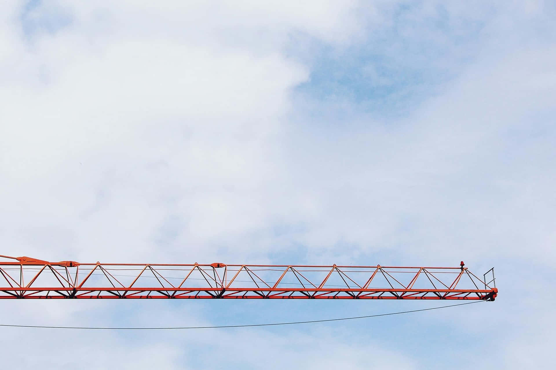 Red Crane Against Blue Sky Background