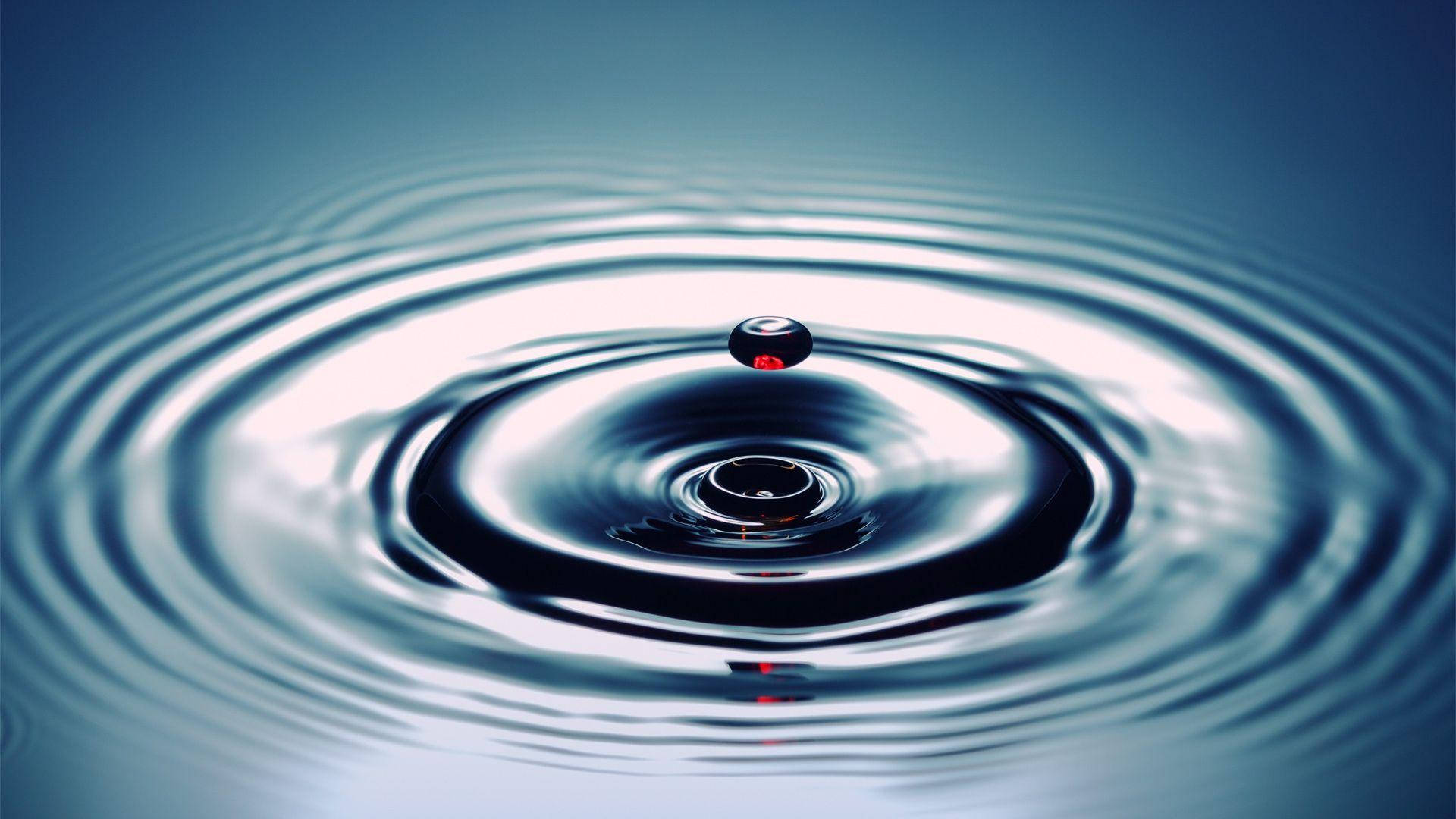 Red Drop On Rippling Water Background