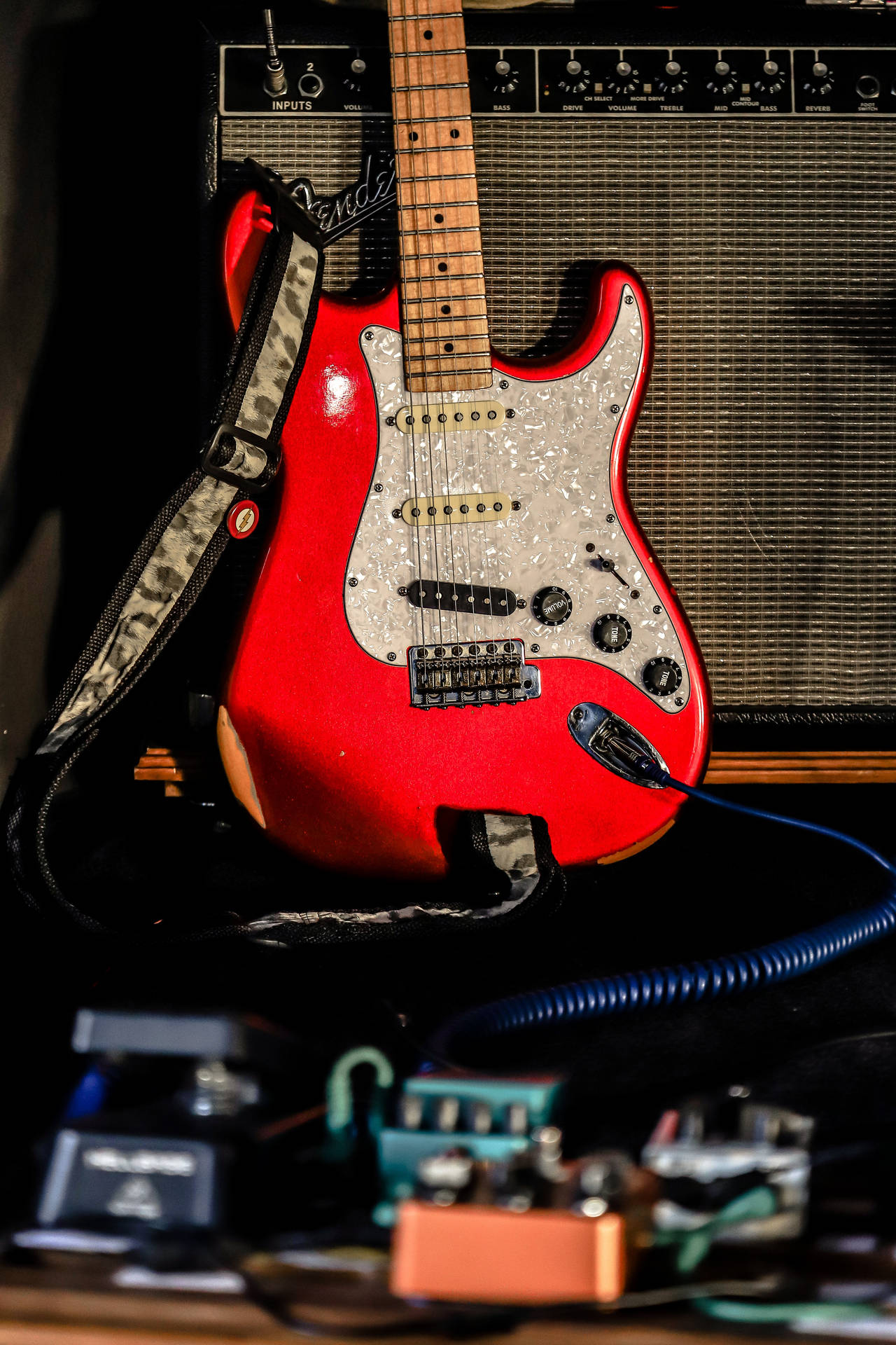 Red Electric Guitar With Amplifier Background