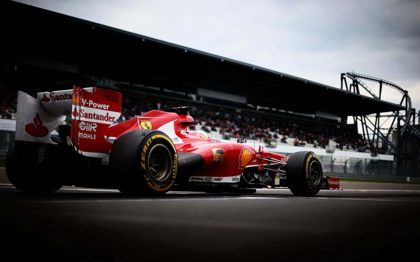 Red Ferrari F1 Car Dominating The Track Background