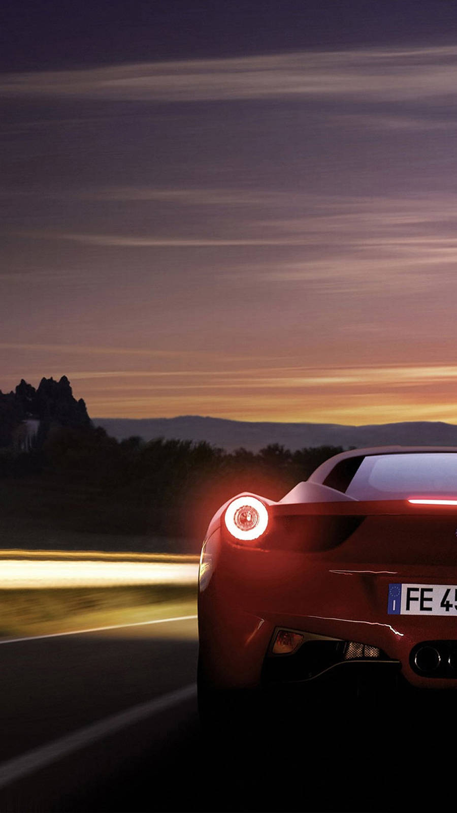 Red Ferrari Phone Against Purple Sky Background