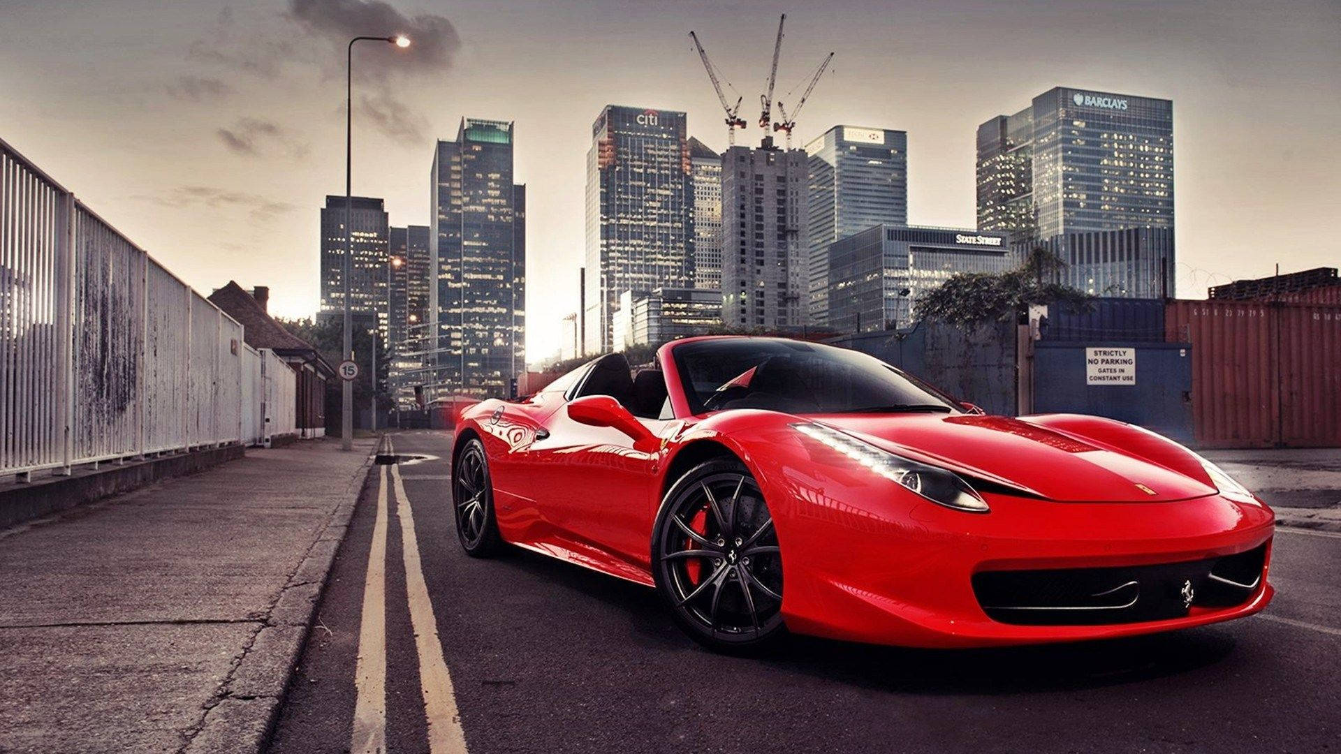 Red Ferrari Sitting On A Race Track Background