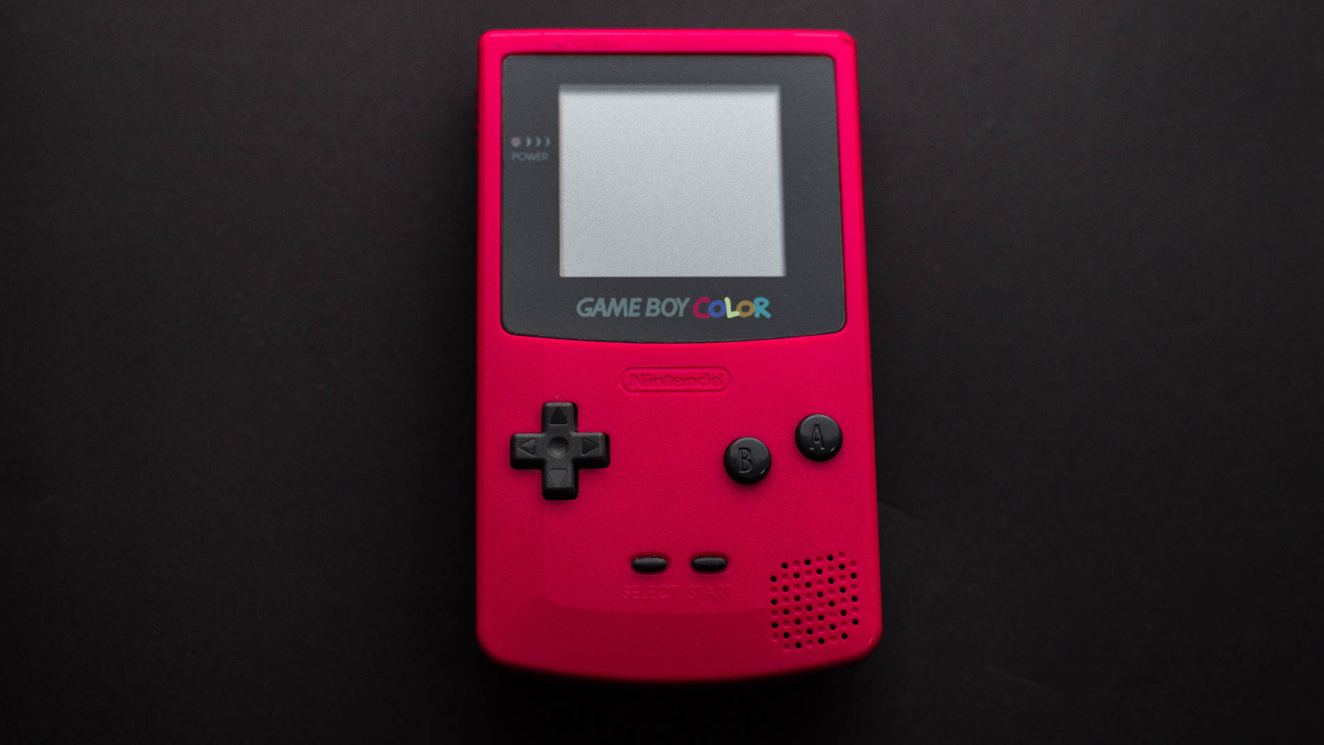 Red Game Boy Color On Black Surface