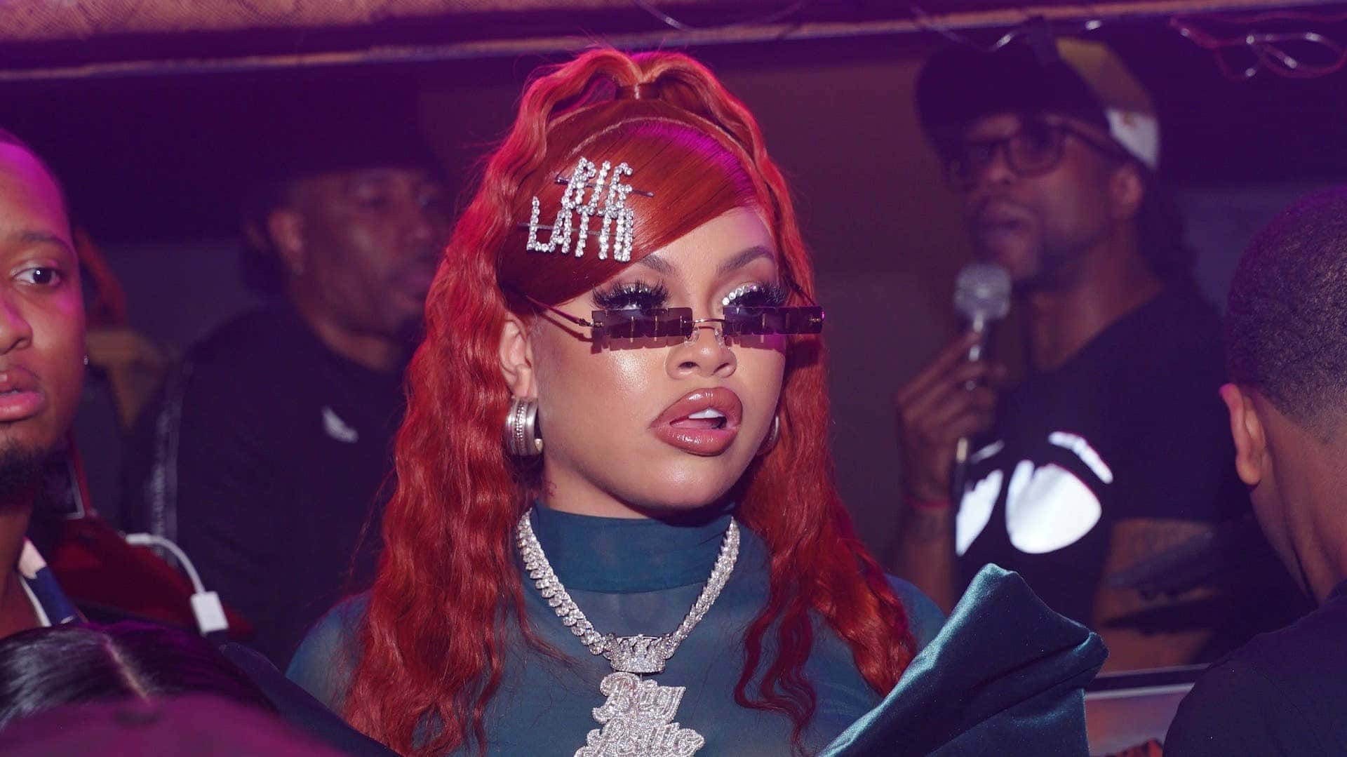 Red Haired_ Performer_with_ Sparkling_ Hairpin_and_ Sunglasses Background