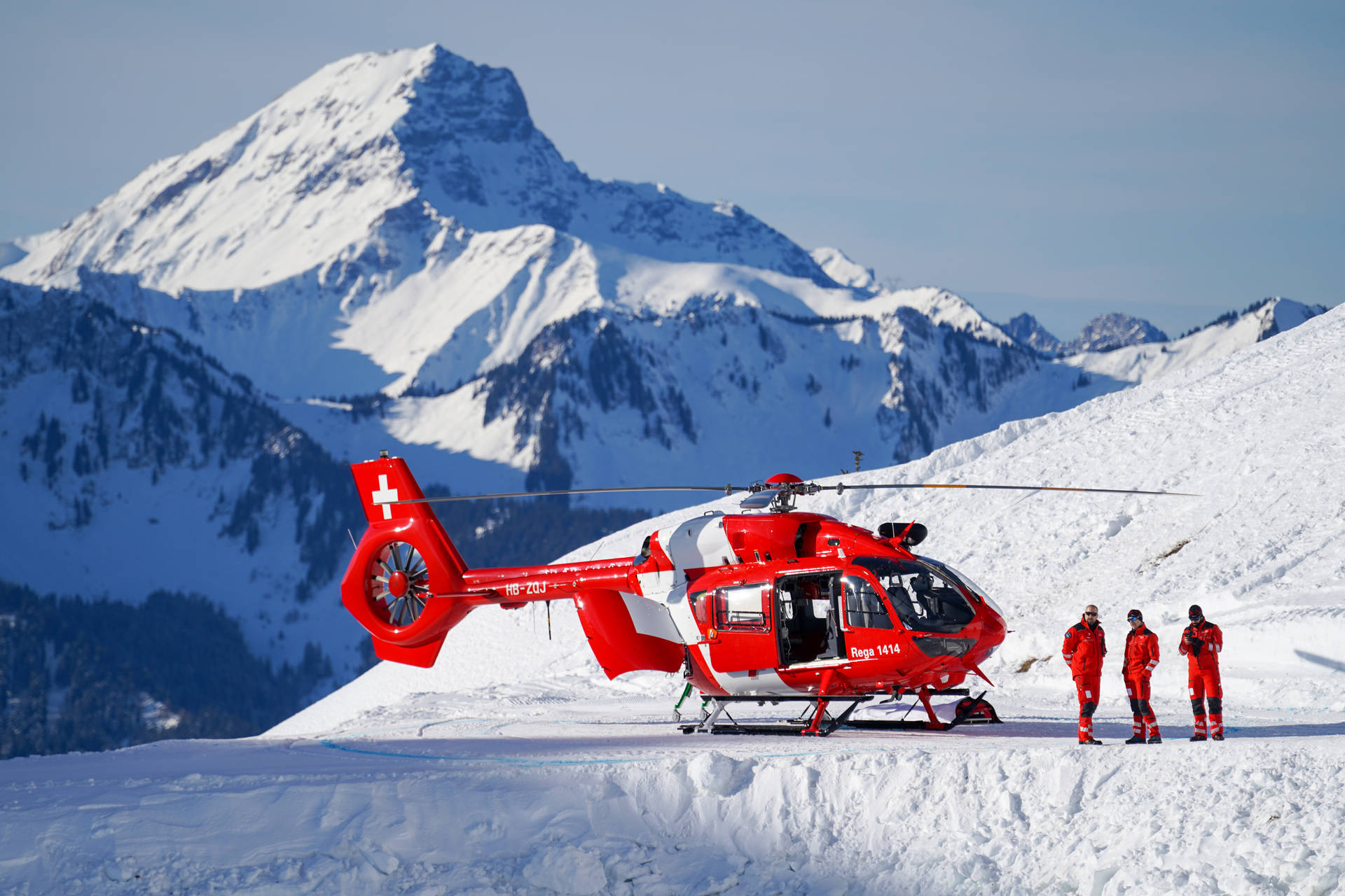 Red Helicopter On Snowy Mountain Background
