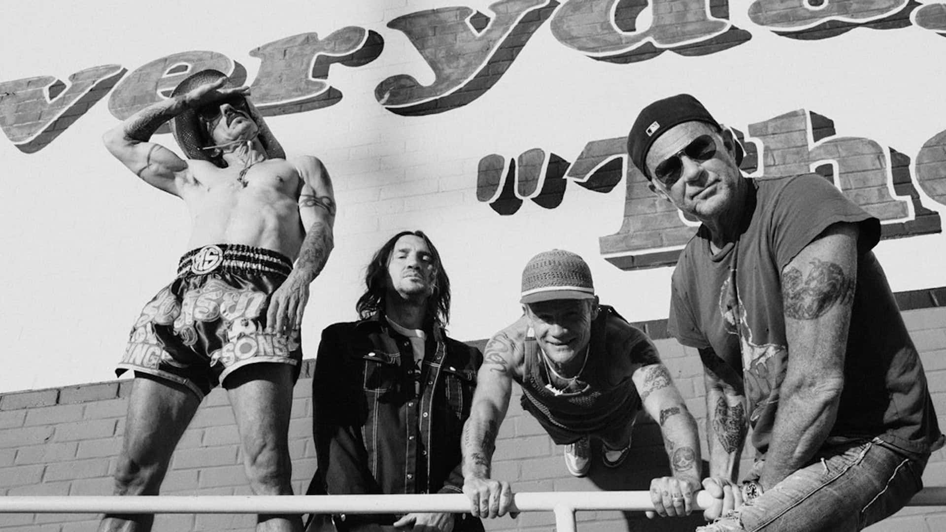 Red Hot Chili Peppers With A Sign Background