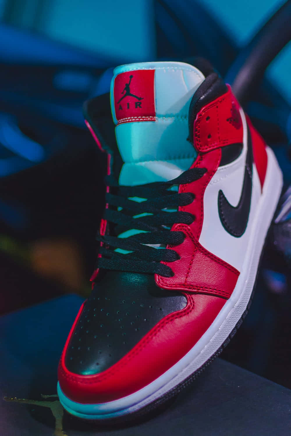 Red Jordan Shoes Under Black Light Background