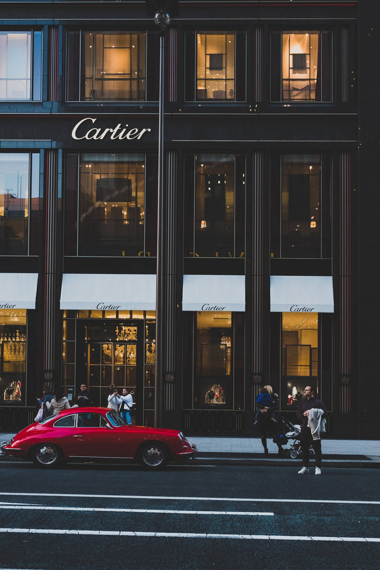 Red Luxury Car Outside Cartier Background