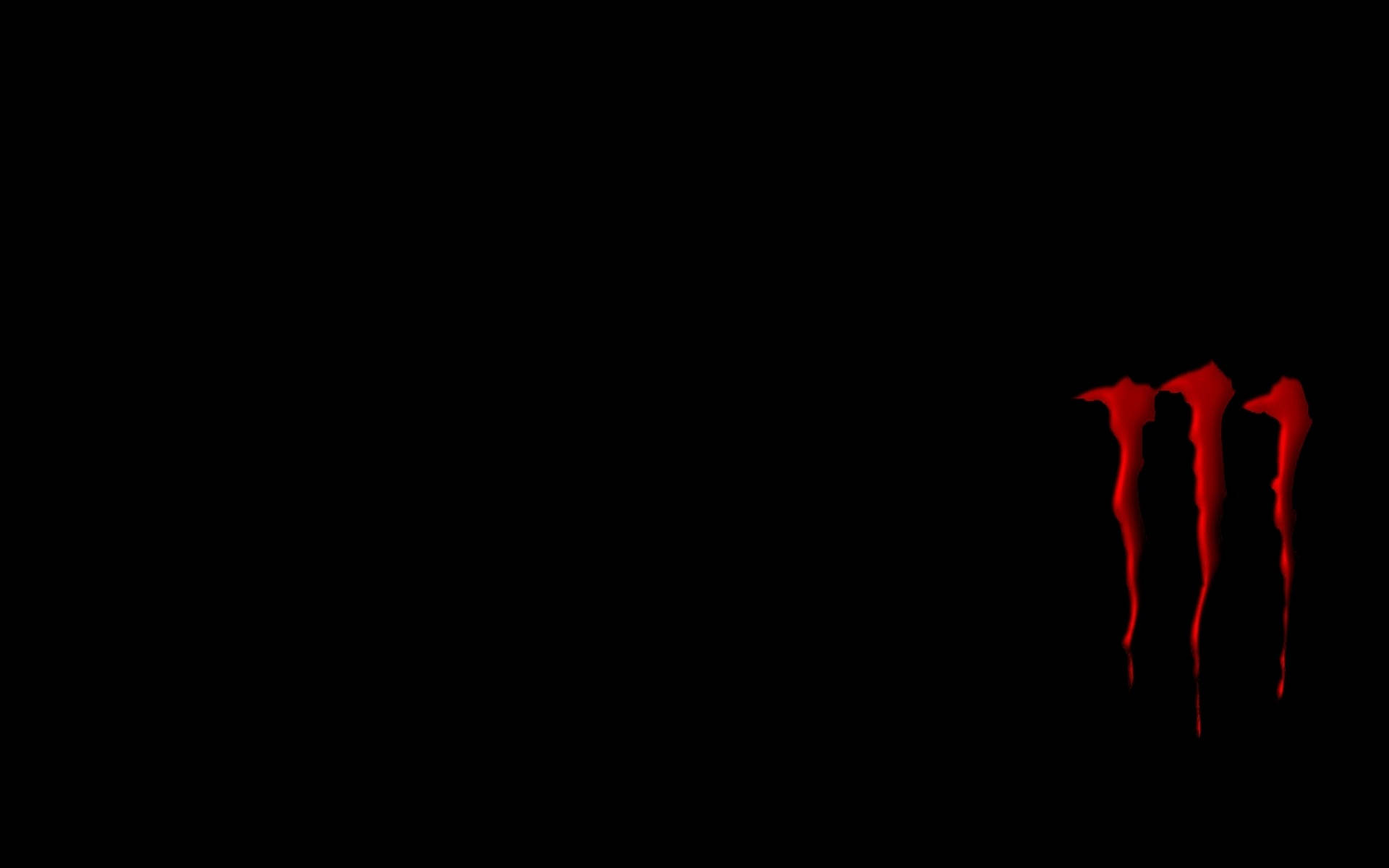 Red Monster Logo On A Minimalistic Black Background Background