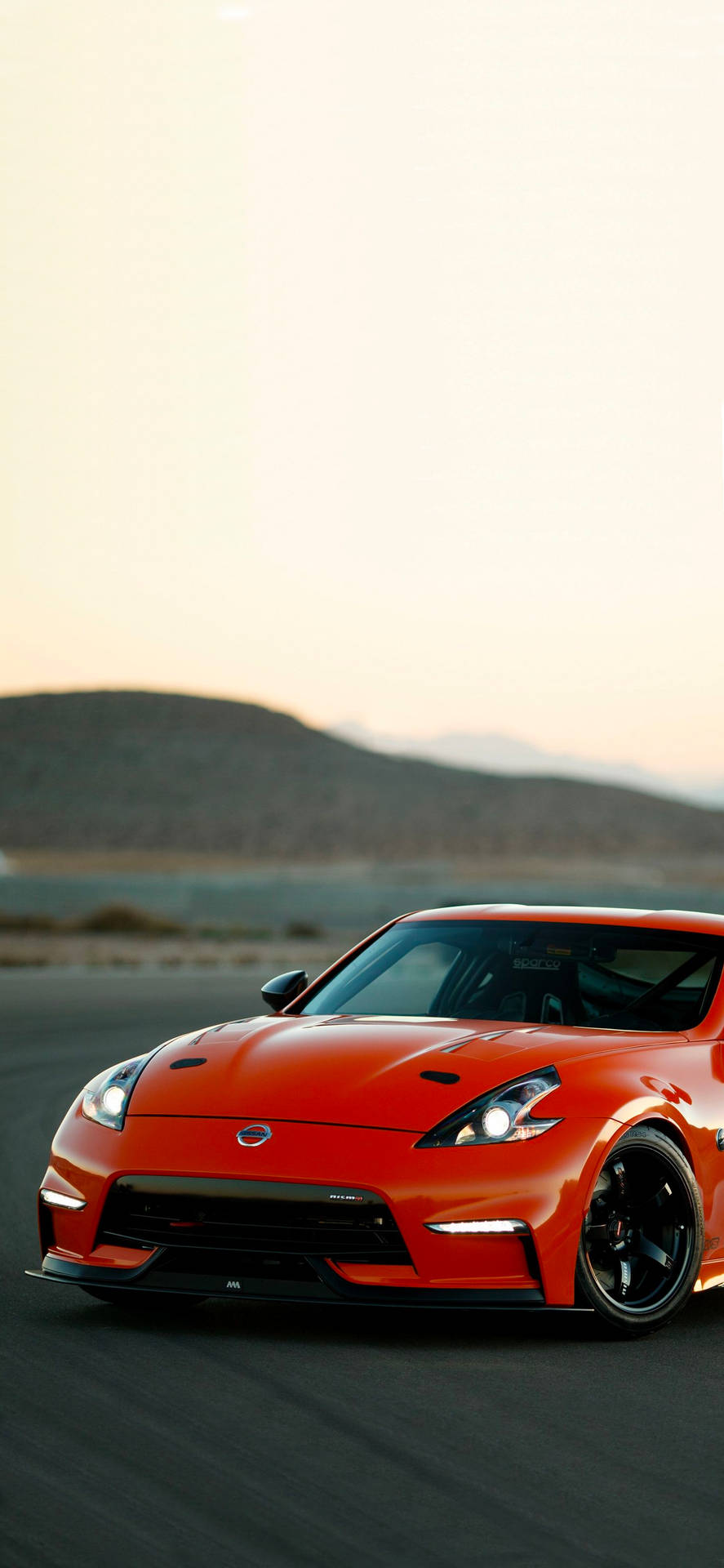 Red Nissan 370z With A Hill Background