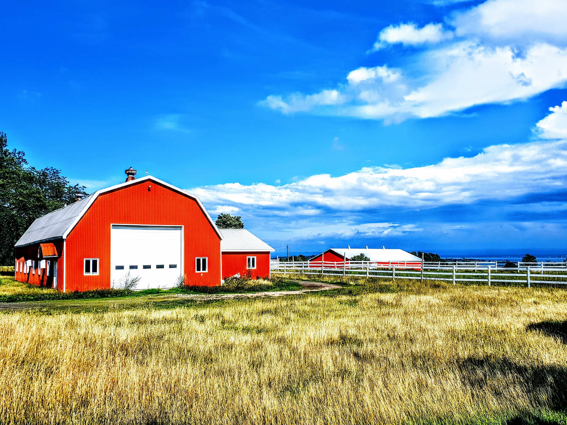 Red Orange Painted Barn Shed In Farm Background