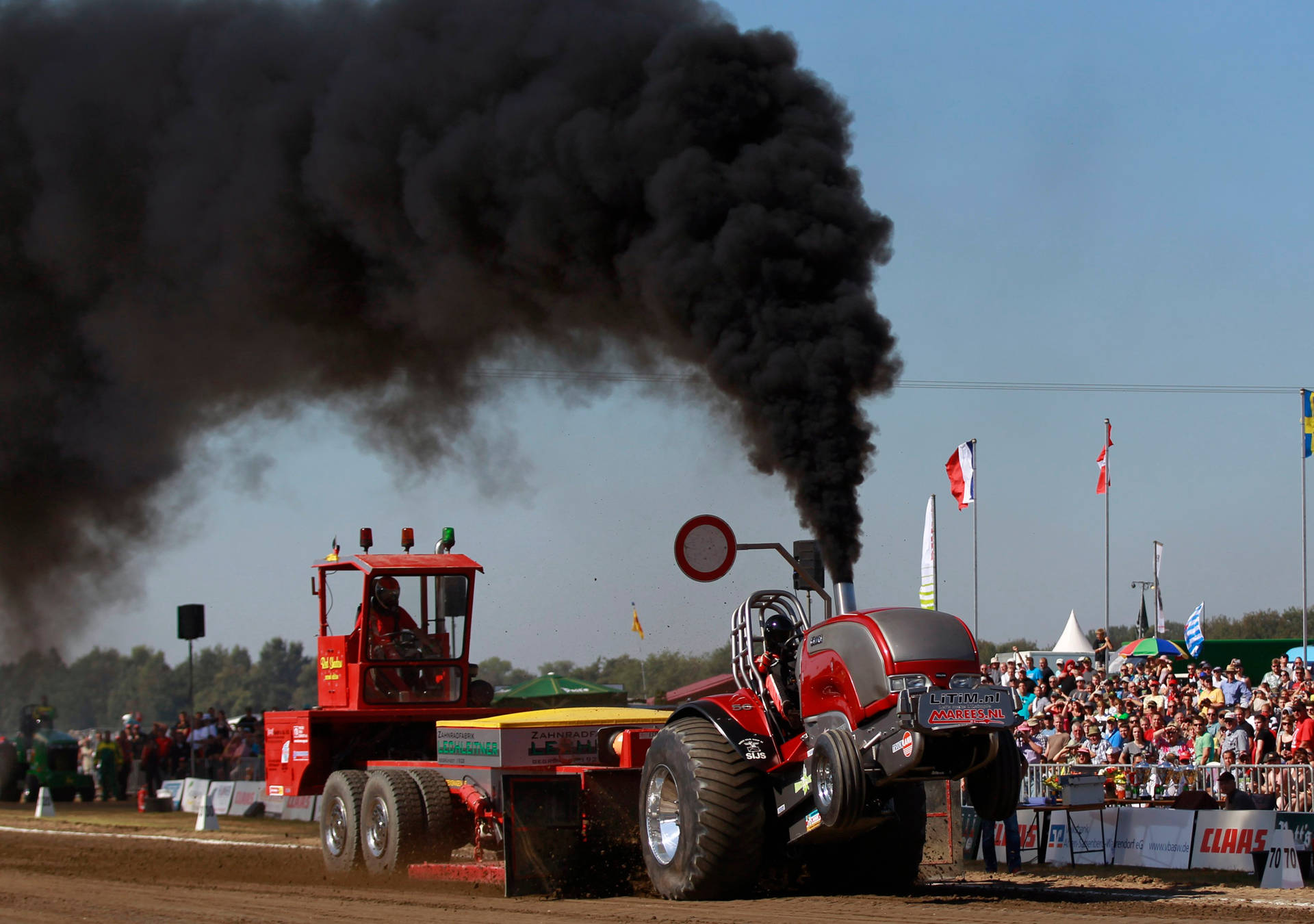 Red Pulling Tractor With Black Smoke Background